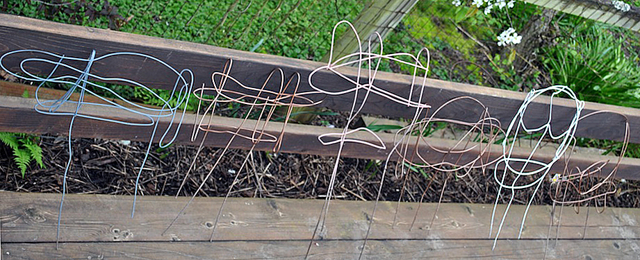 A row of wire garden art creations
